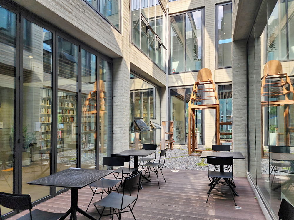 An installation artwork of artist, Lee Boo-rok, with tables and chairs located in the courtyard of the Kim Geun-tae Memorial Library-Archives.